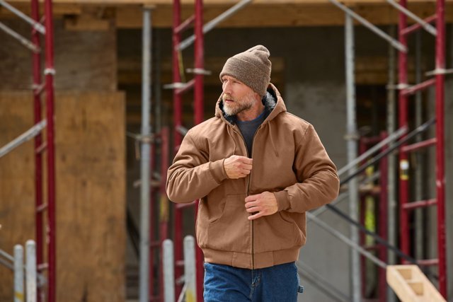 Male construction worker in rugged looking clothes.