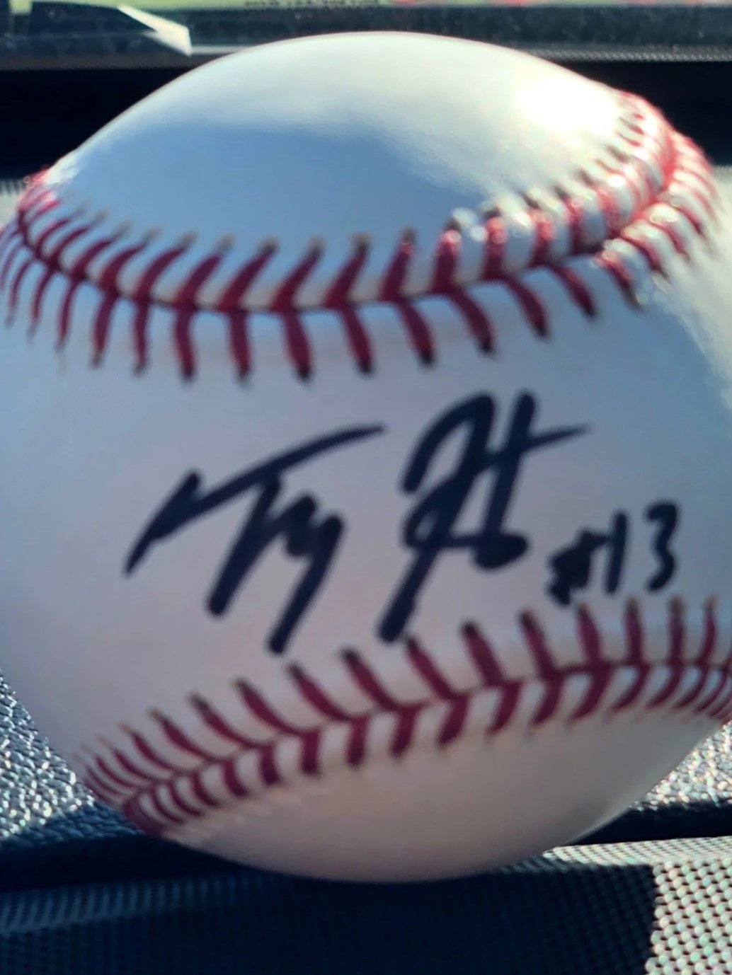 Official Major League Baseball with red stitching and blue printed signature, marked as 2013 season.