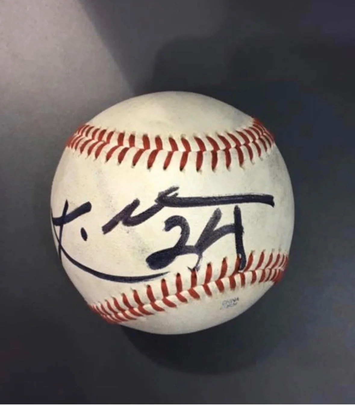 Baseball with an autograph and arrow drawn on it
