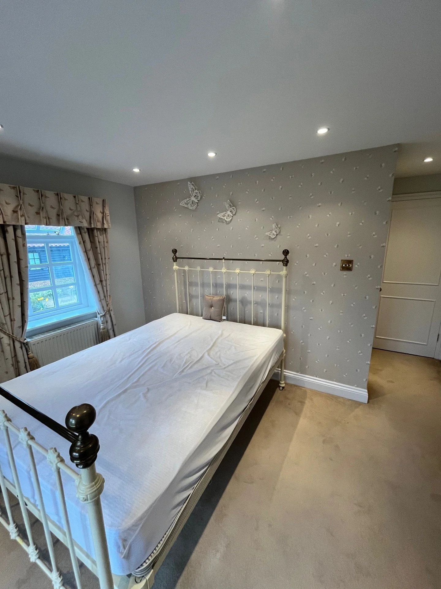 Wallpapered bedroom in Dedham, Essex with feature wall and a professional finish