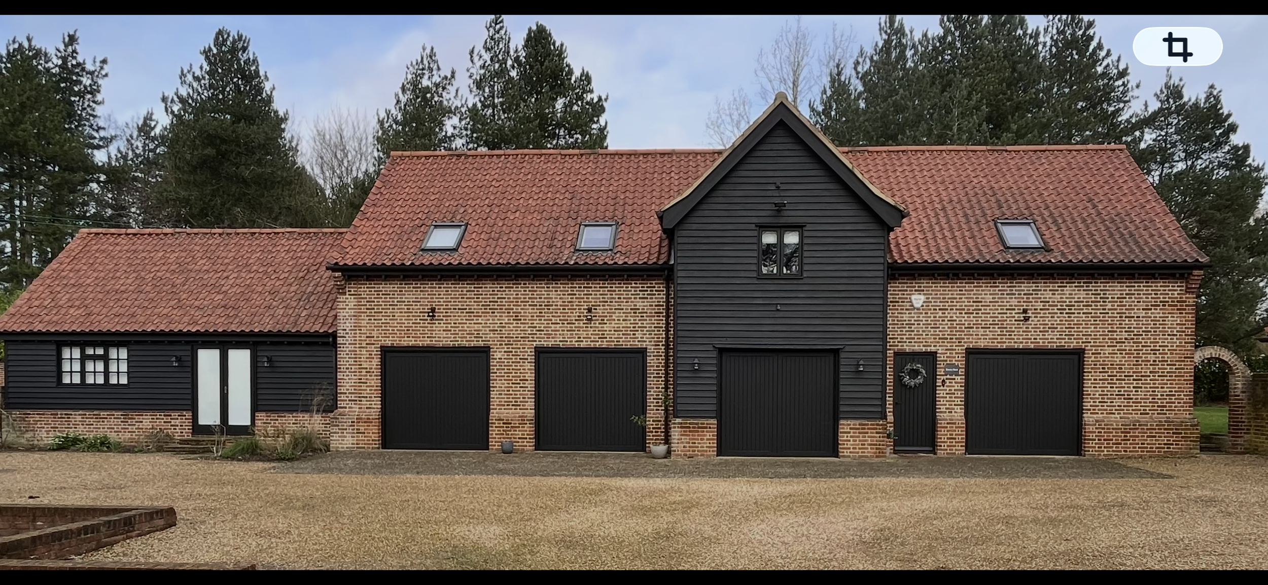 Exterior painting in Dedham with black cladding finish on barn conversion by Bergman Decorations