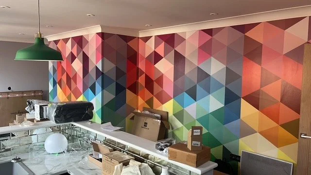 Geometric feature wall wallpaper installation in living room Colchester, Essex by Bergman Decorations