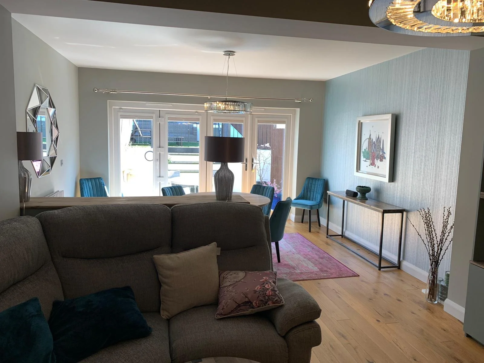 Lounge diner with wallpapered feature wall and grey paint finish during redecoration in Maldon