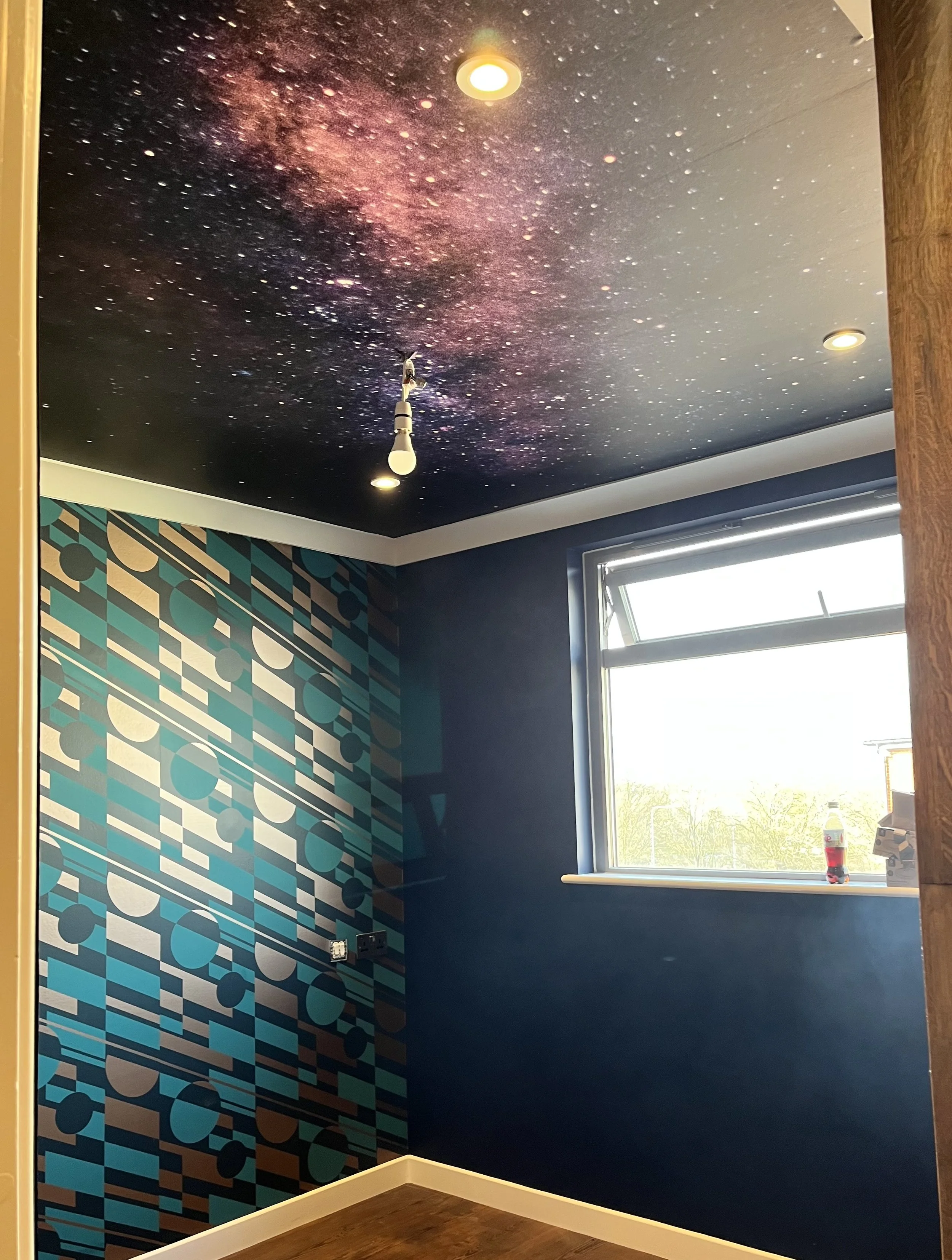 Full room redecoration in Colchester - Wallpapered ceiling and feature wall installation by Bergman Decorations.