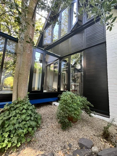 Rear courtyard elevation completed as part of the Bridge House exterior decorating project, with Sadolin Obsidian applied to the cladding, windows, doors and exterior timber for a durable contemporary finish. 