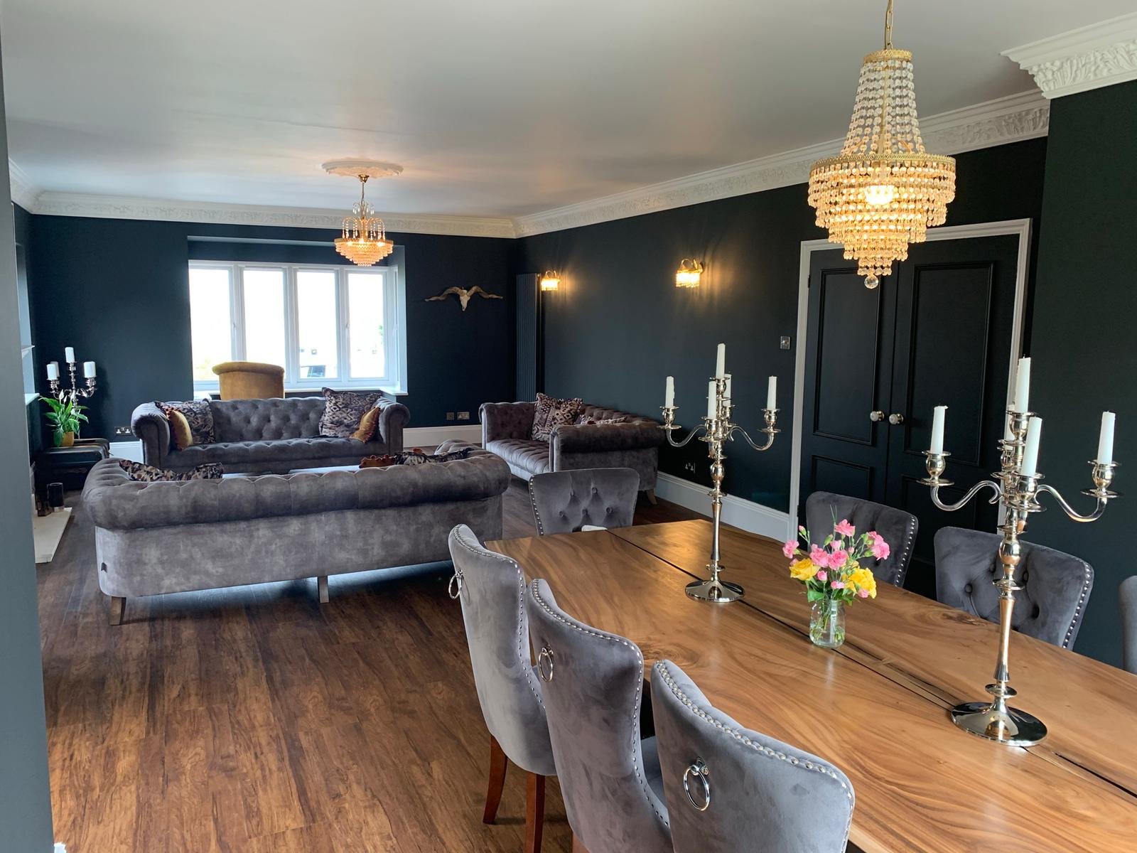 Professional painter and decorator in Manningtree completing a full lounge redecoration using Little Greene black paint, including a sprayed finish to the detailed cornice for a high-end result
