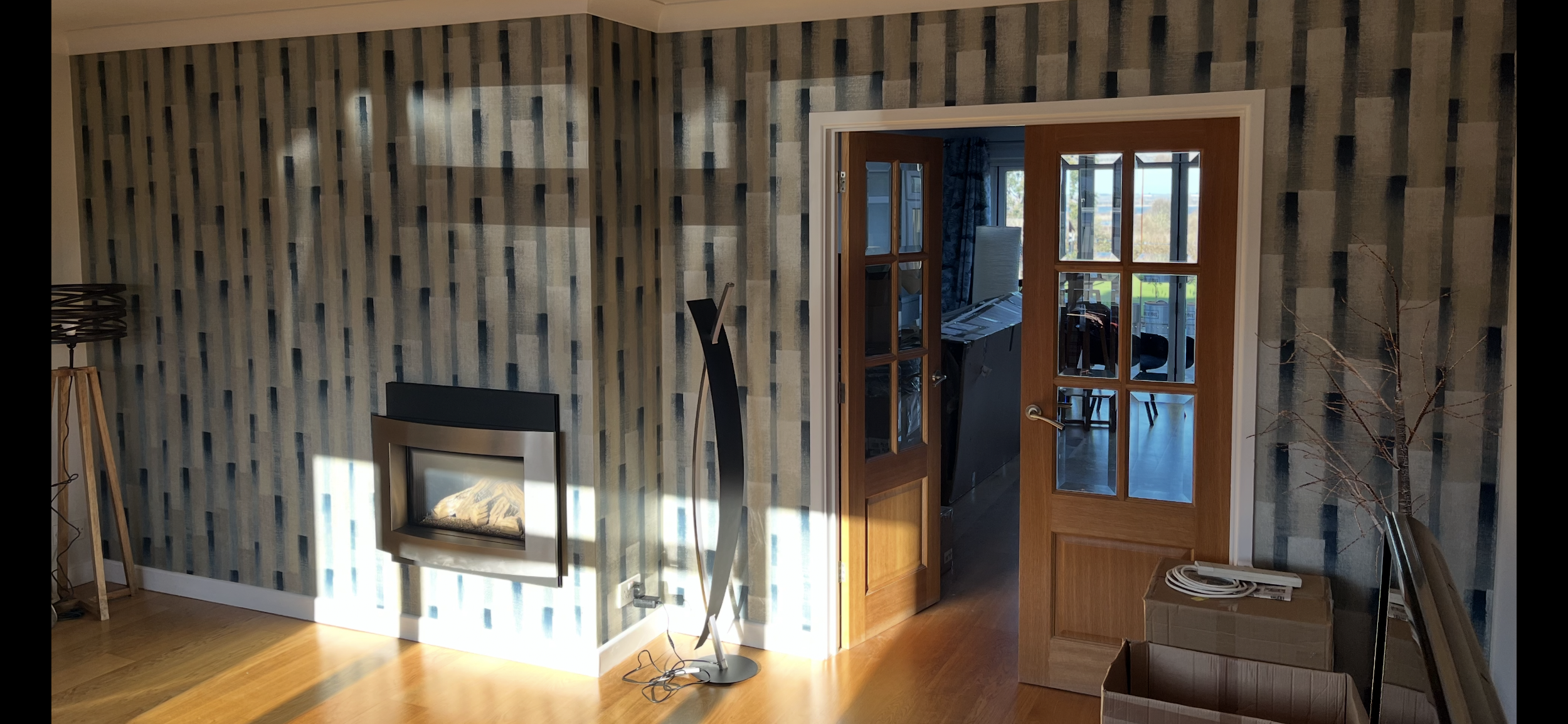 Living room feature wallpaper wall in Walton-on-the-Naze by Bergman Decorations.