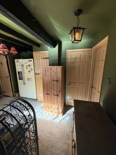 Traditional kitchen redecoration completed in Tollesbury, Essex, with refreshed walls, ceiling and woodwork while preserving the original character and exposed beams.