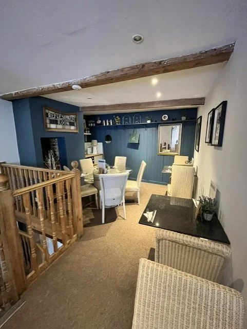 Dulux Heritage feature wall and refreshed seating area at Stewarts Tea Room, Chelmsford, blending modern decorating with the building's historic charm.