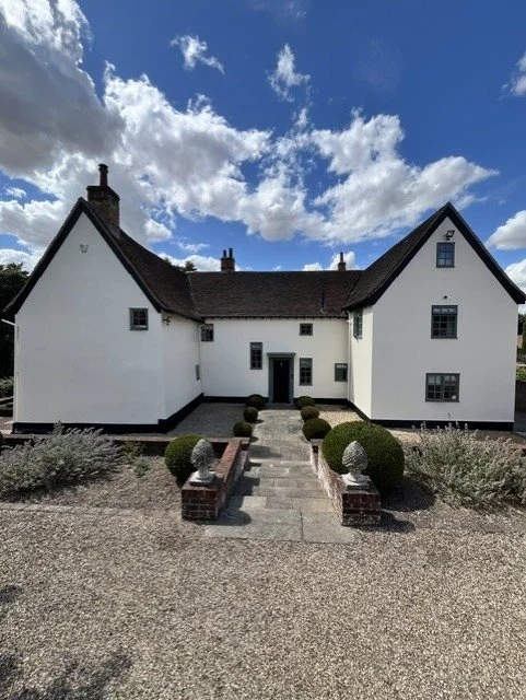 Complete exterior farmhouse redecoration in Dedham, Essex, using Bedec Super-Flex masonry paint in Gardenia, with Bedec Green Barn paint to the windows and Bedec Black Barn paint to the fascias, soffits and doors.