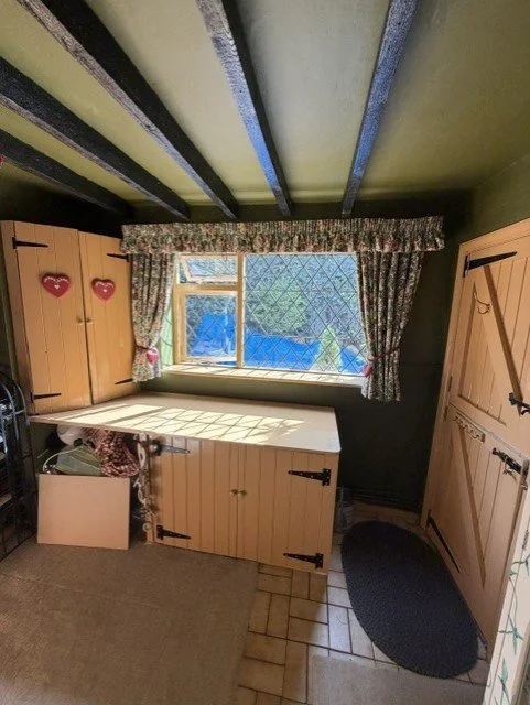 Freshly redecorated kitchen window and storage area, creating a brighter, cleaner finish while maintaining the home's traditional charm.