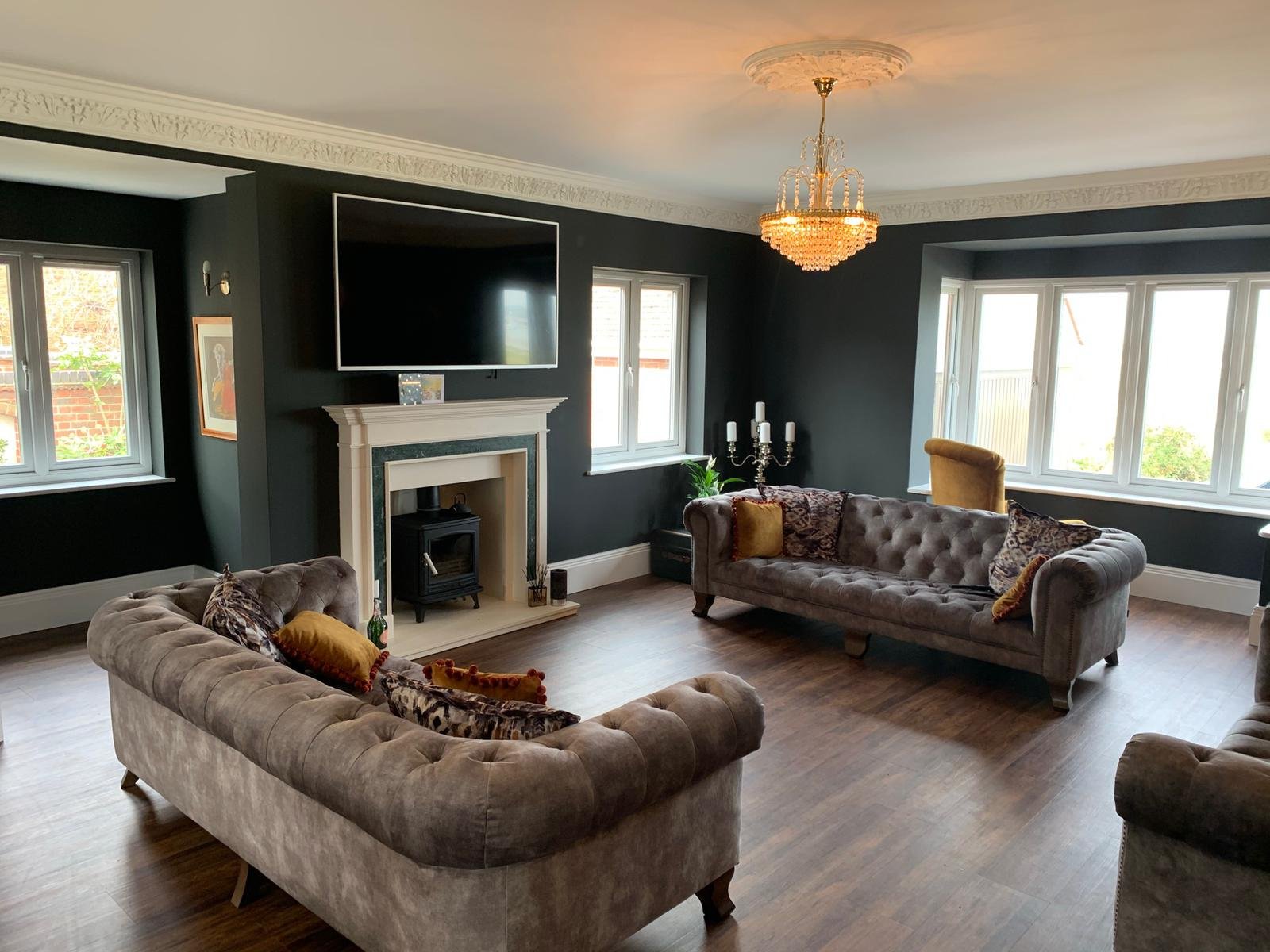 Lounge redecoration in Manningtree featuring black walls in Little Greene paint, original fireplace detail and clean, sharp finishing throughout