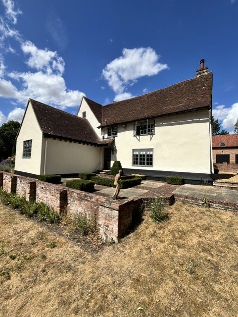 Side elevation of a period farmhouse in Dedham, Essex, fully prepared and repainted with Bedec exterior coatings, including Gardenia masonry and black Barn Paint on the facias and soffits.