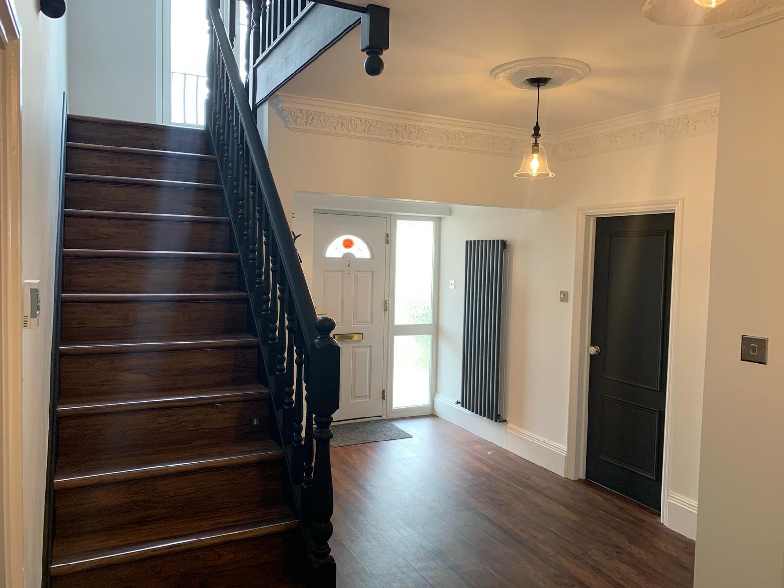 Hallway and staircase redecoration with black staircase and doors in Little Greene Estate Eggshell and white walls in Manningtree