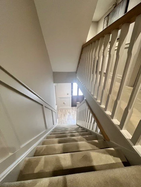 Staircase painting and decorating in Sandon with detailed preparation and a consistent across walls and woodwork.