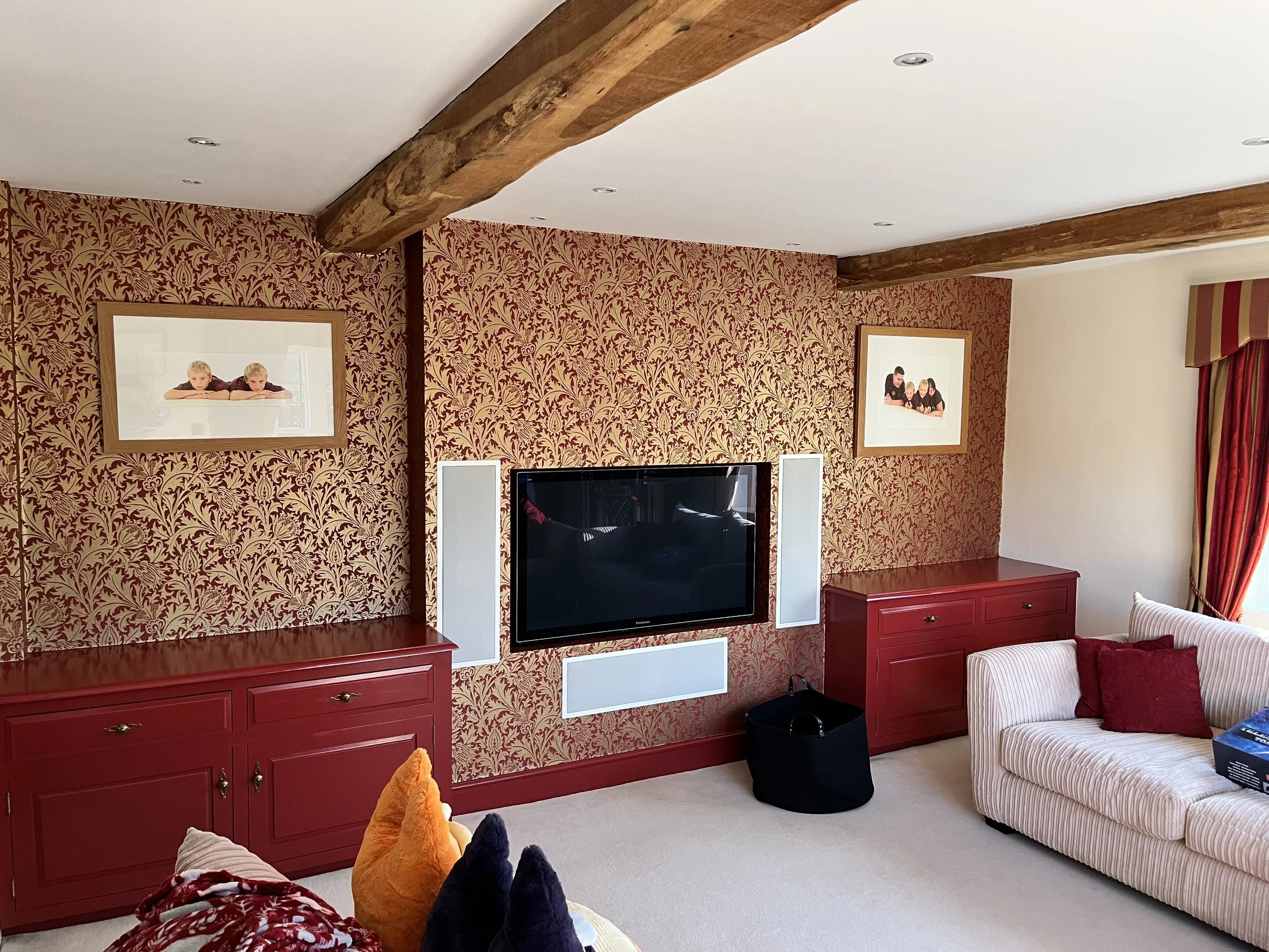 Living room redecoration in Dedham with feature wallpaper wall and painted woodwork by Bergman Decorations.