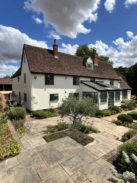 Rear elevation and garden entrance professionally redecorated using Bedec Gardenia masonry paint, Green Barn Paint on the windows and Black Barn Paint on the facias, soffits and doors. 