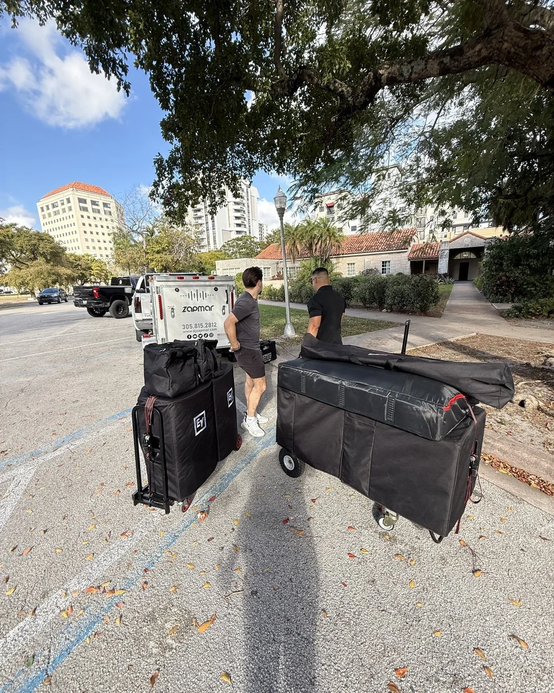 DJ Zapmar team unloading sound and lighting equipment before a Miami event