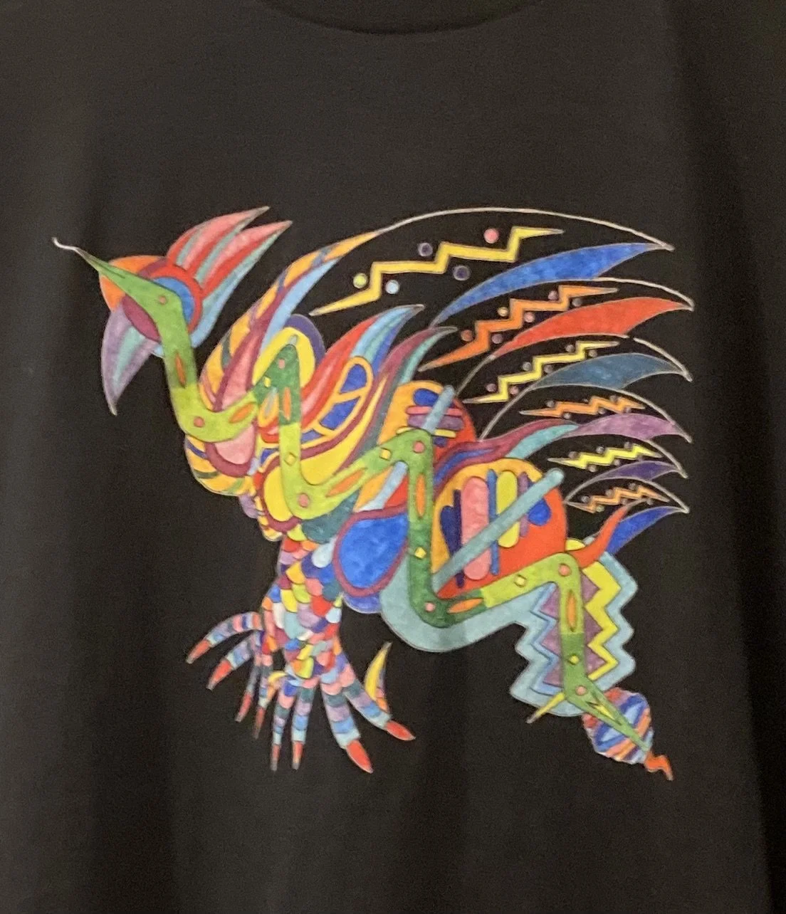 Colorful, abstract illustration of a dragon with intricate, geometric patterns on a black background.