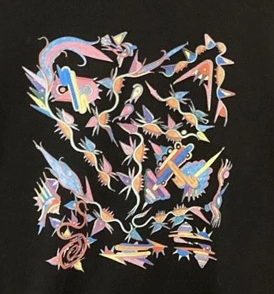 A colorful, abstract illustration of a man's face made up of various fish, knives, and other sharp objects against a black background.