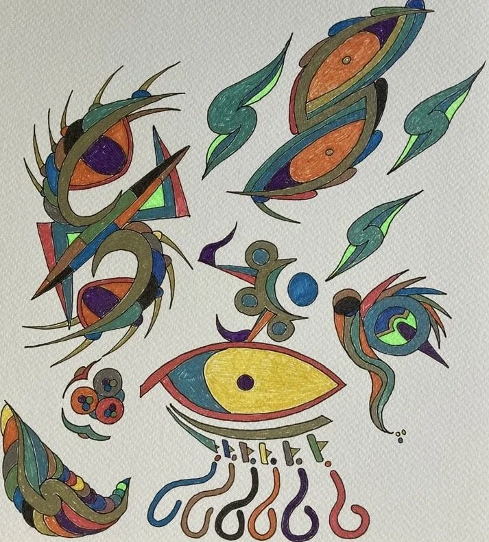 Colorful abstract drawing featuring various shapes, lines, and patterns, including a central eye shape, steam or trail-like designs, and eye-like motifs, created with colored markers or pens.