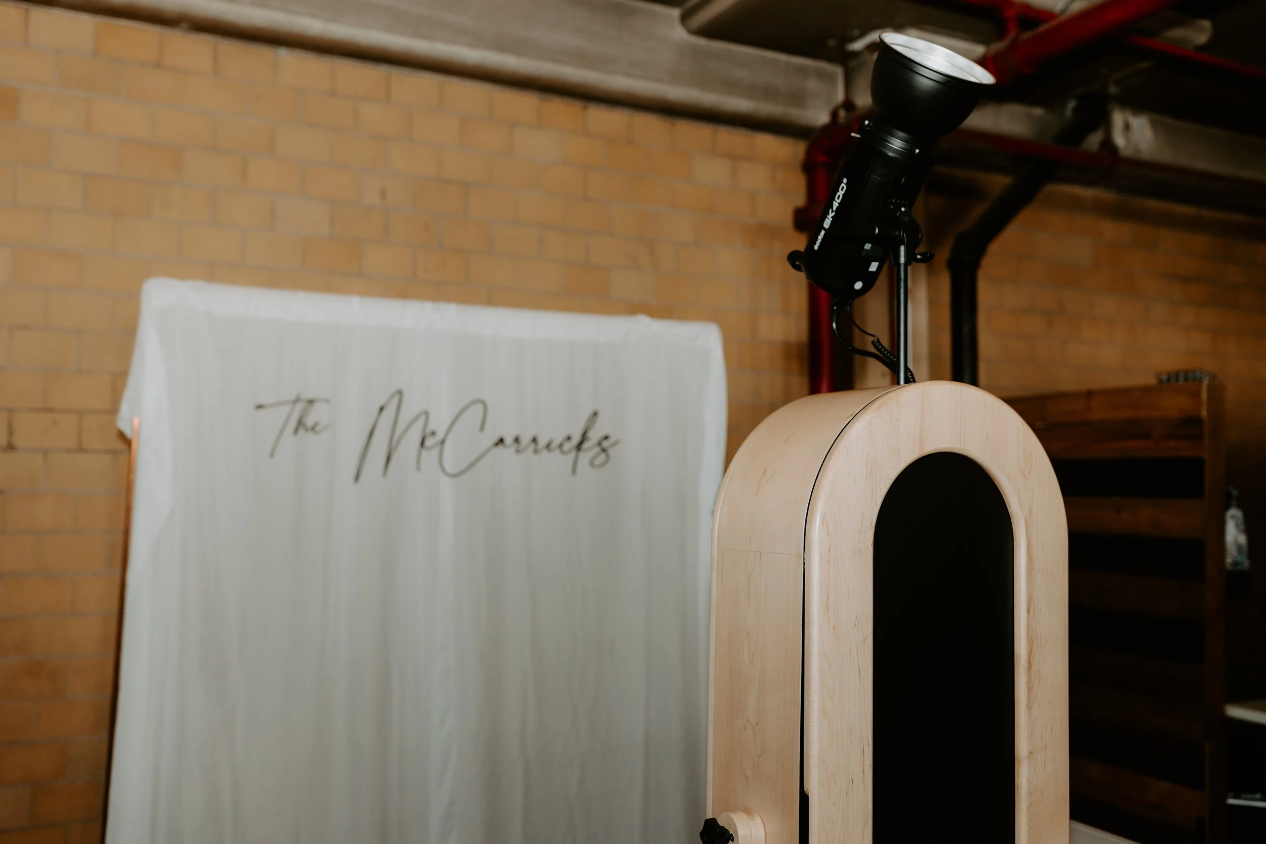 Romantic wedding photo booth setup with warm lighting