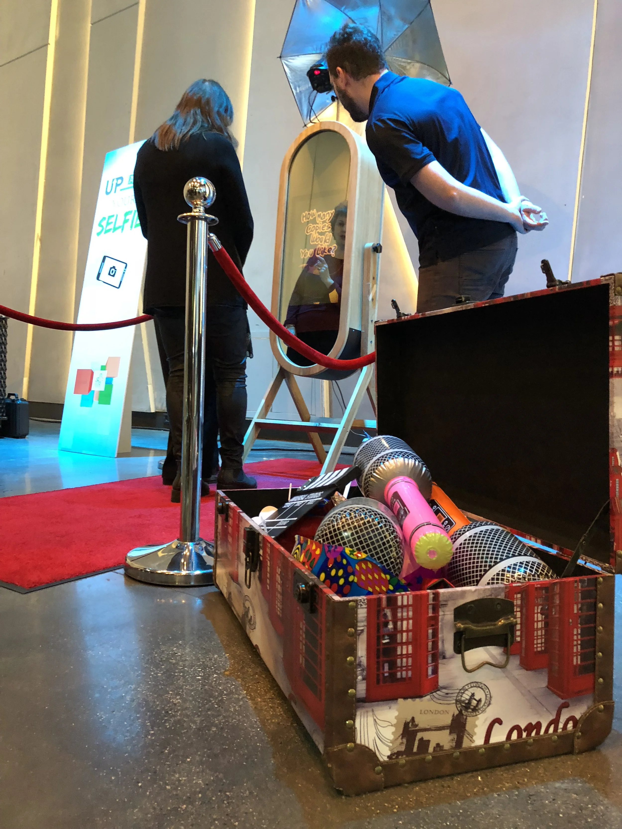 Photo booth prop table with hats, glasses, and signs
