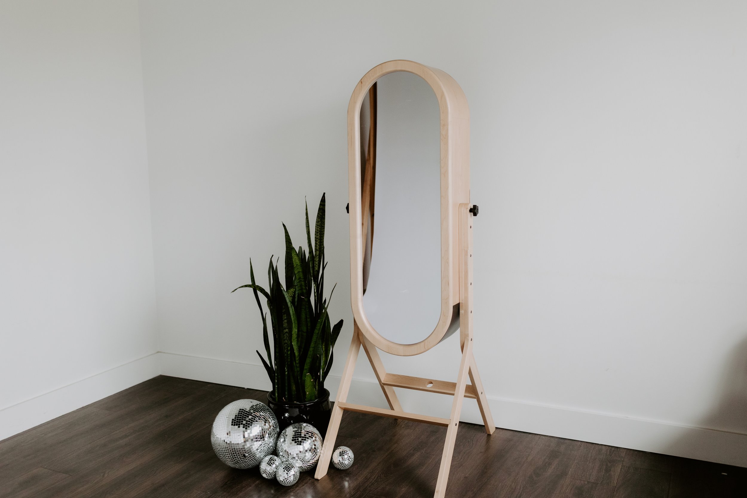Luxury mirror photo booth rental setup against white wall