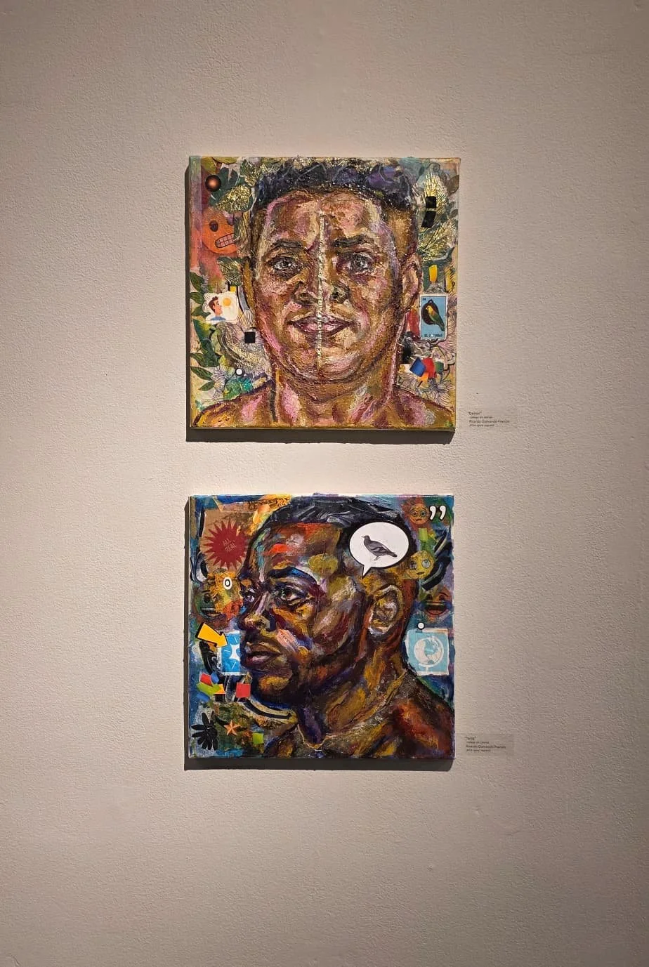 Two colorful paintings depicting African American individuals on a gallery wall, surrounded by patterned and abstract backgrounds.