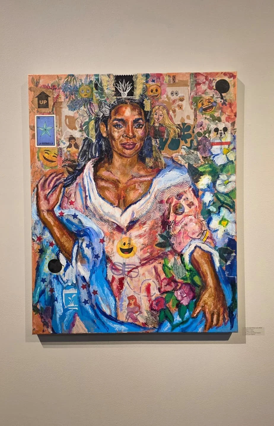 A colorful portrait of a woman with dark hair, wearing a white shirt with blue and red accents, surrounded by vibrant patterns, emojis, flowers, and various small illustrations.