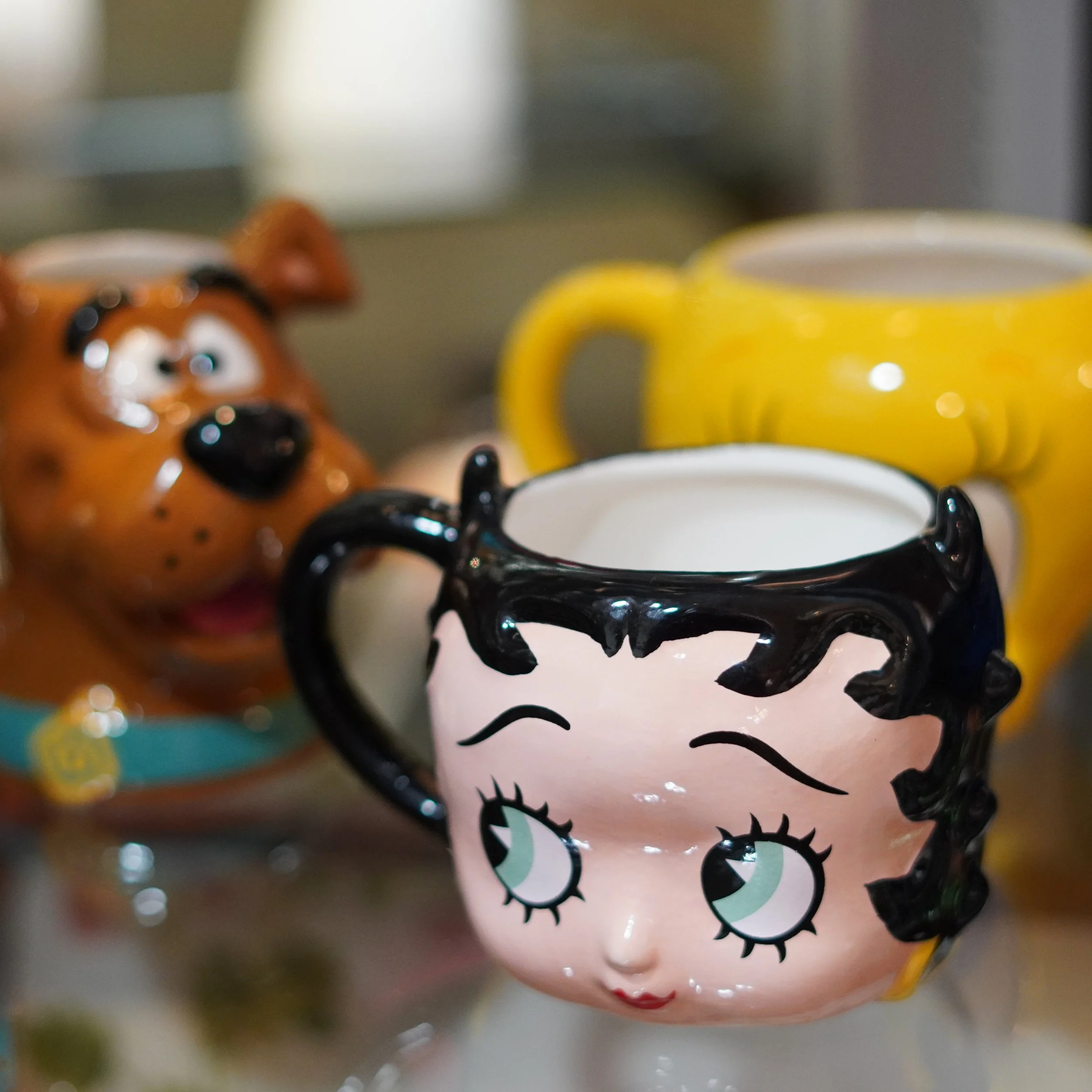 Character-themed mugs featuring Betty Boop, Scooby-Doo, and Tweety avalable inside The Westin Bonaventure Hotel at The French kitchen Convenience & Liquor Store