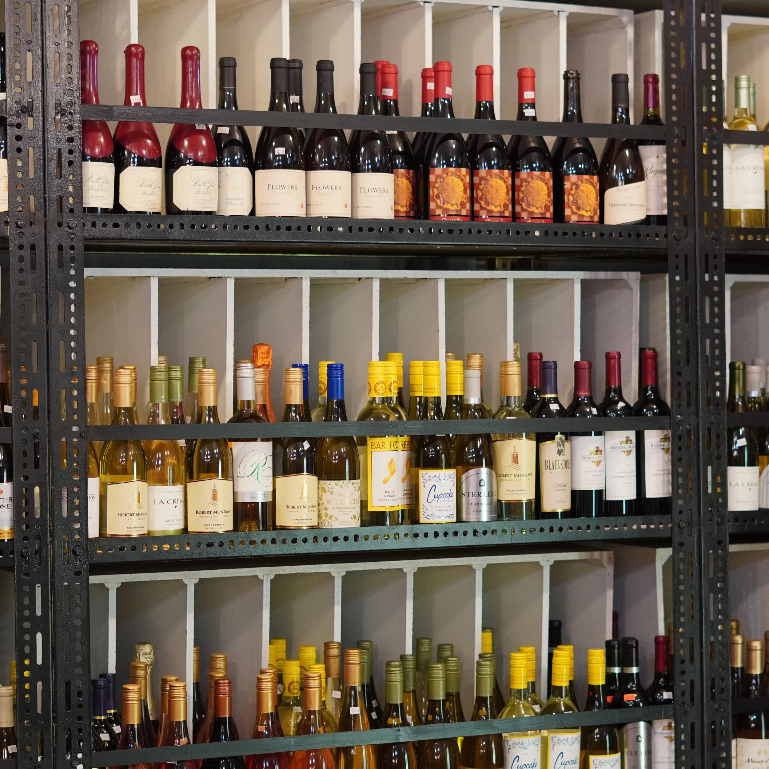 Shelf filled with various bottles of wine, organized on a black metal rack with white cubical dividers.
available at The French Kitchen , one-stop shop on 4th Fllor of The Westin Bonaventure Hotel