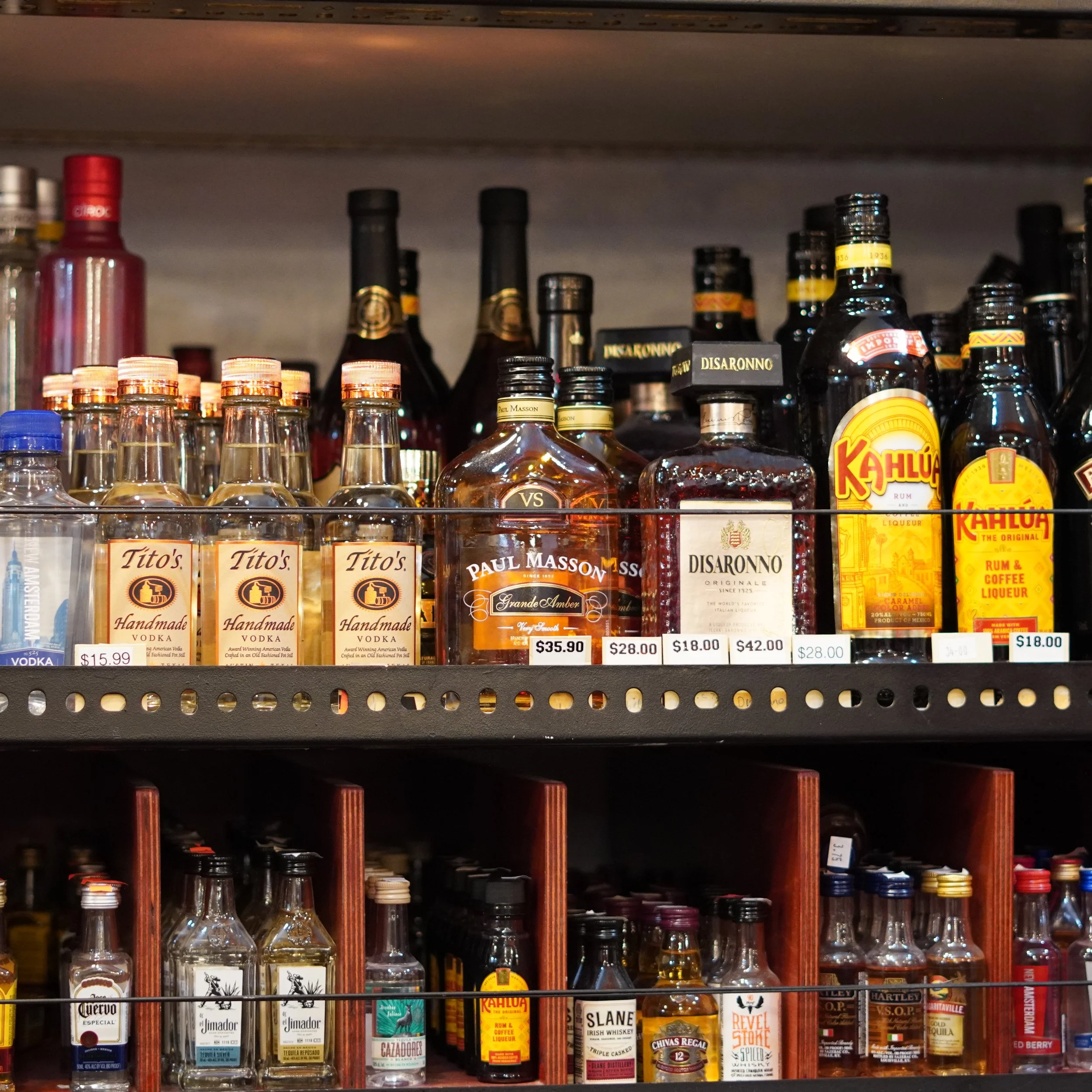 Shelf of assorted alcohol bottles including vodka, rum, and whiskey in a store display.
available at The French Kitchen , one-stop shop on 4th Fllor of The Westin Bonaventure Hotel