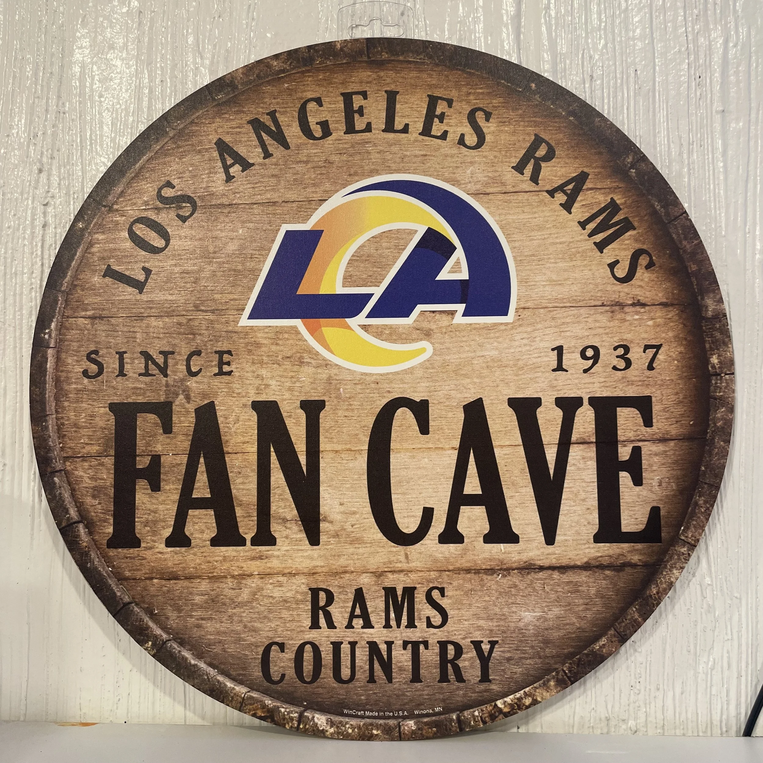 Souvenir wooden circular sign featuring the los Angeles Rams logo, on display inside The Westin Bonaventure Hotel at The French kitchen Convenience & Liquor Store