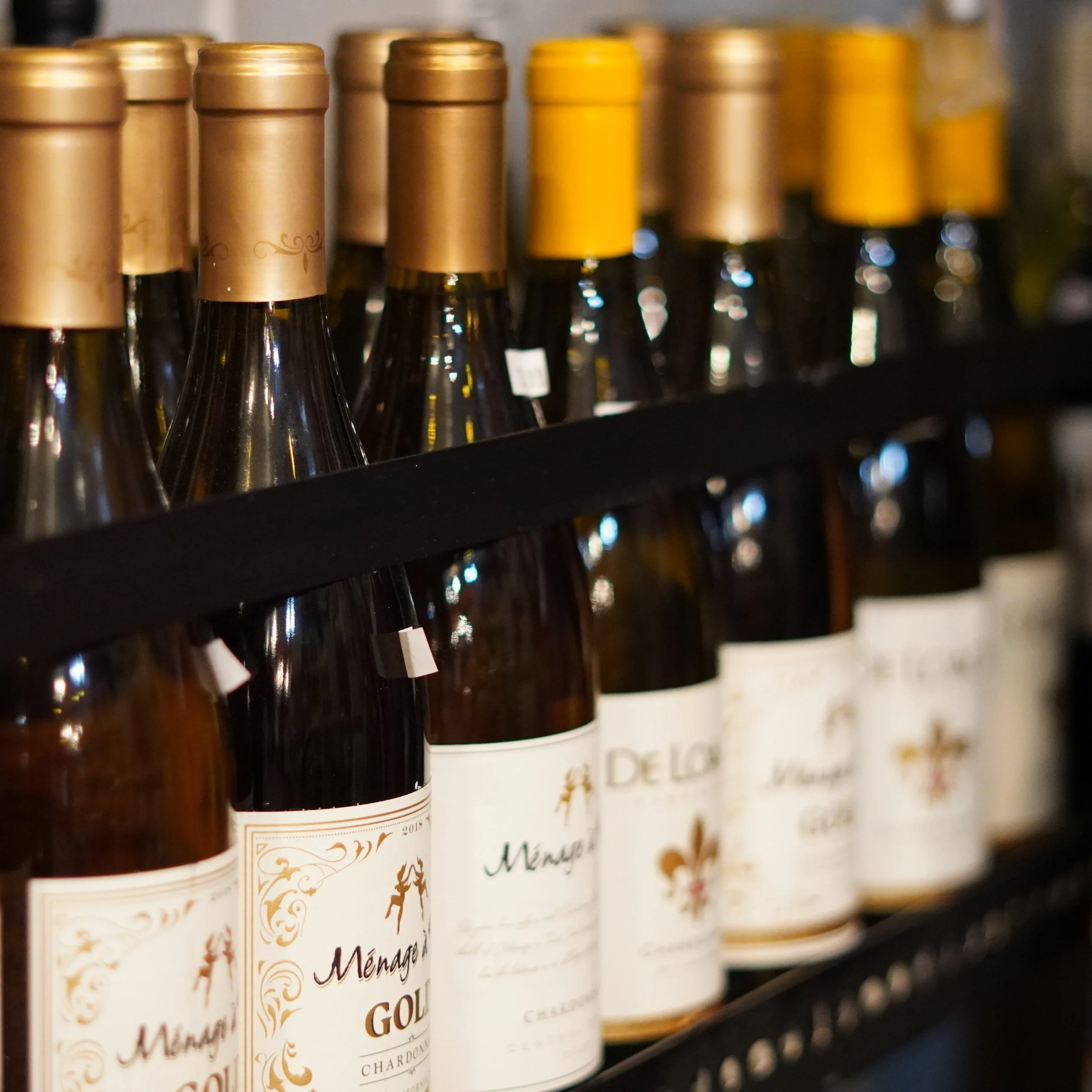 Several bottles of wine on a shelf, with gold and yellow caps, in a wine store or cellar.
available at The French Kitchen , one-stop shop on 4th Fllor of The Westin Bonaventure Hotel