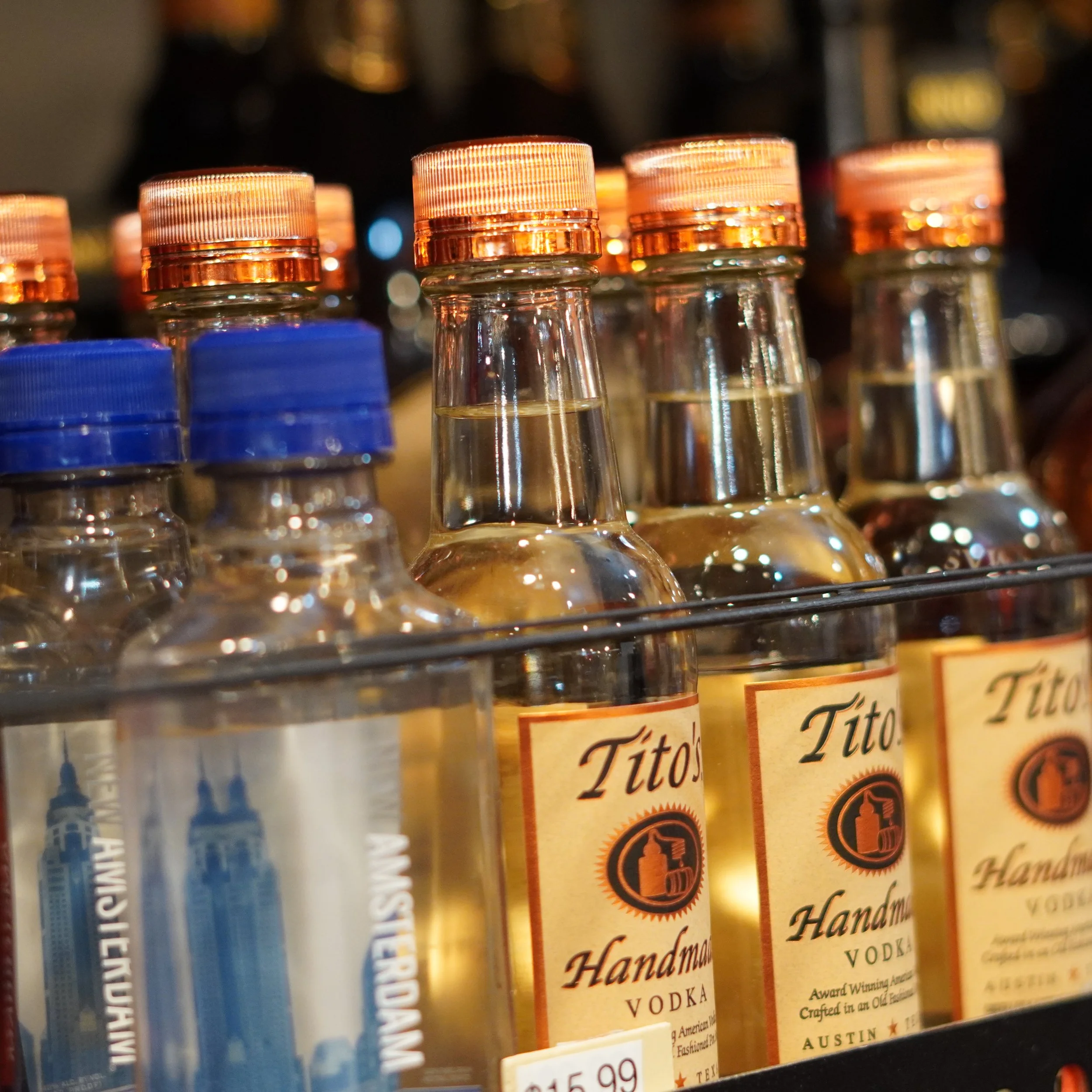 Close-up of bottles of Tito's Handmade Vodka on store shelf, with orange caps and a yellow label featuring a black and white logo
available at The French Kitchen , one-stop shop on 4th Fllor of The Westin Bonaventure Hotel