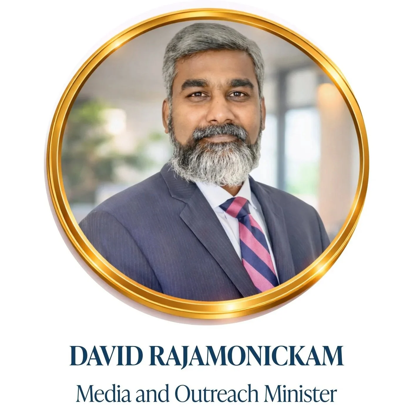 Photograph of David Rajamonickam, a Media and Outreach Minister, in professional attire with a suit and tie, framed by a gold circular border, with text below identifying his name and title.