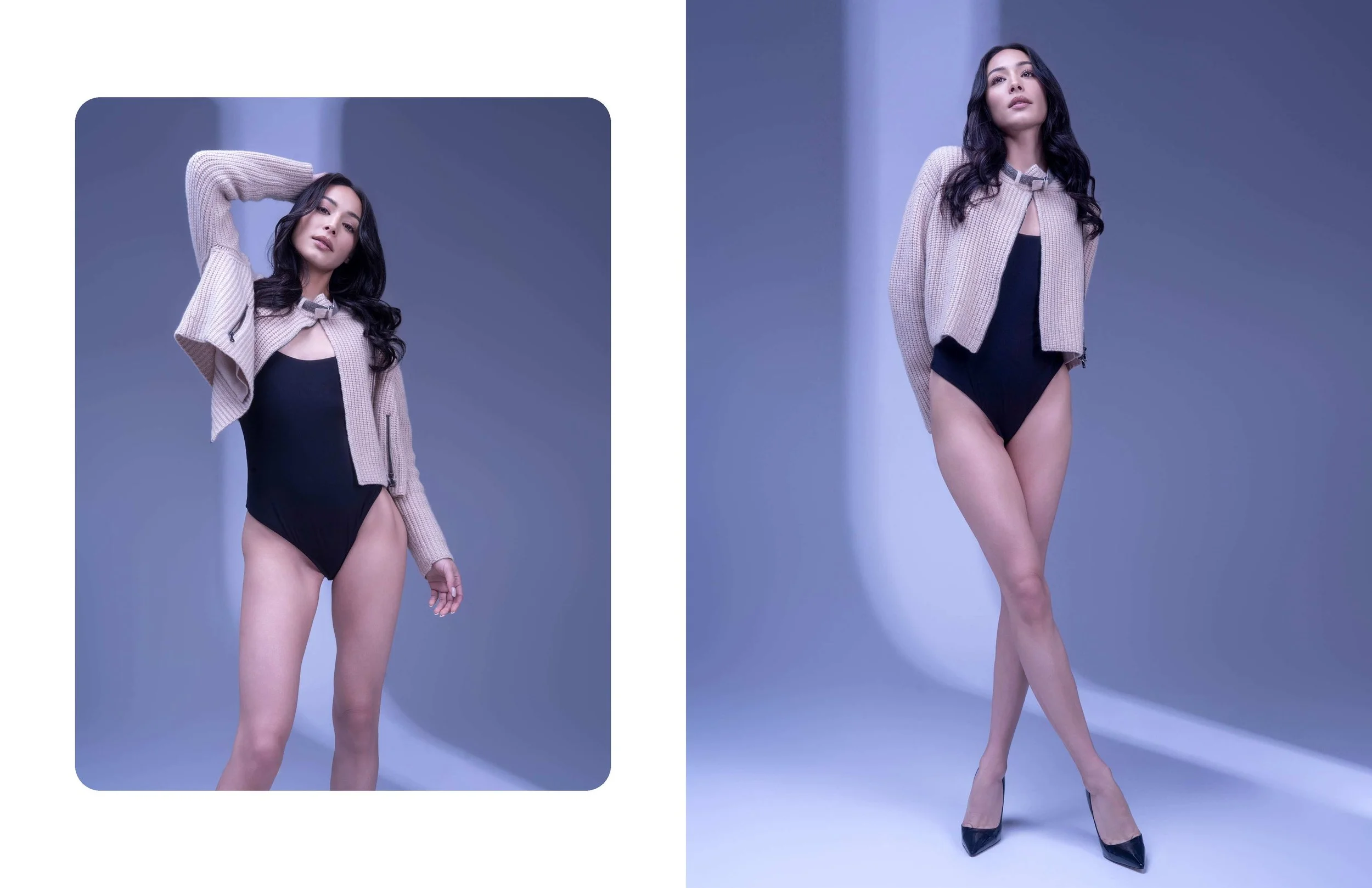 A woman stands confidently against a plain background, wearing a black bodysuit, a beige textured blazer, and black high heels, with dark wavy hair and serious facial expression.