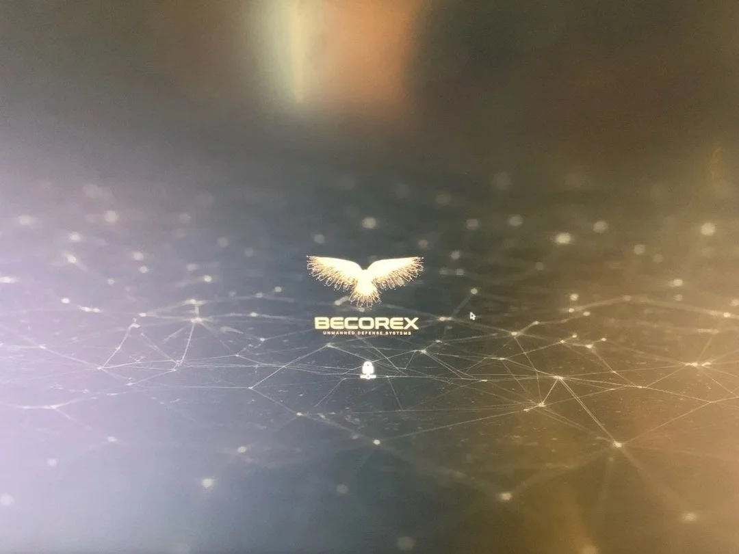 Computer screen displaying the BECORX logo with a stylized bird or wings above it, surrounded by a digital network design.
