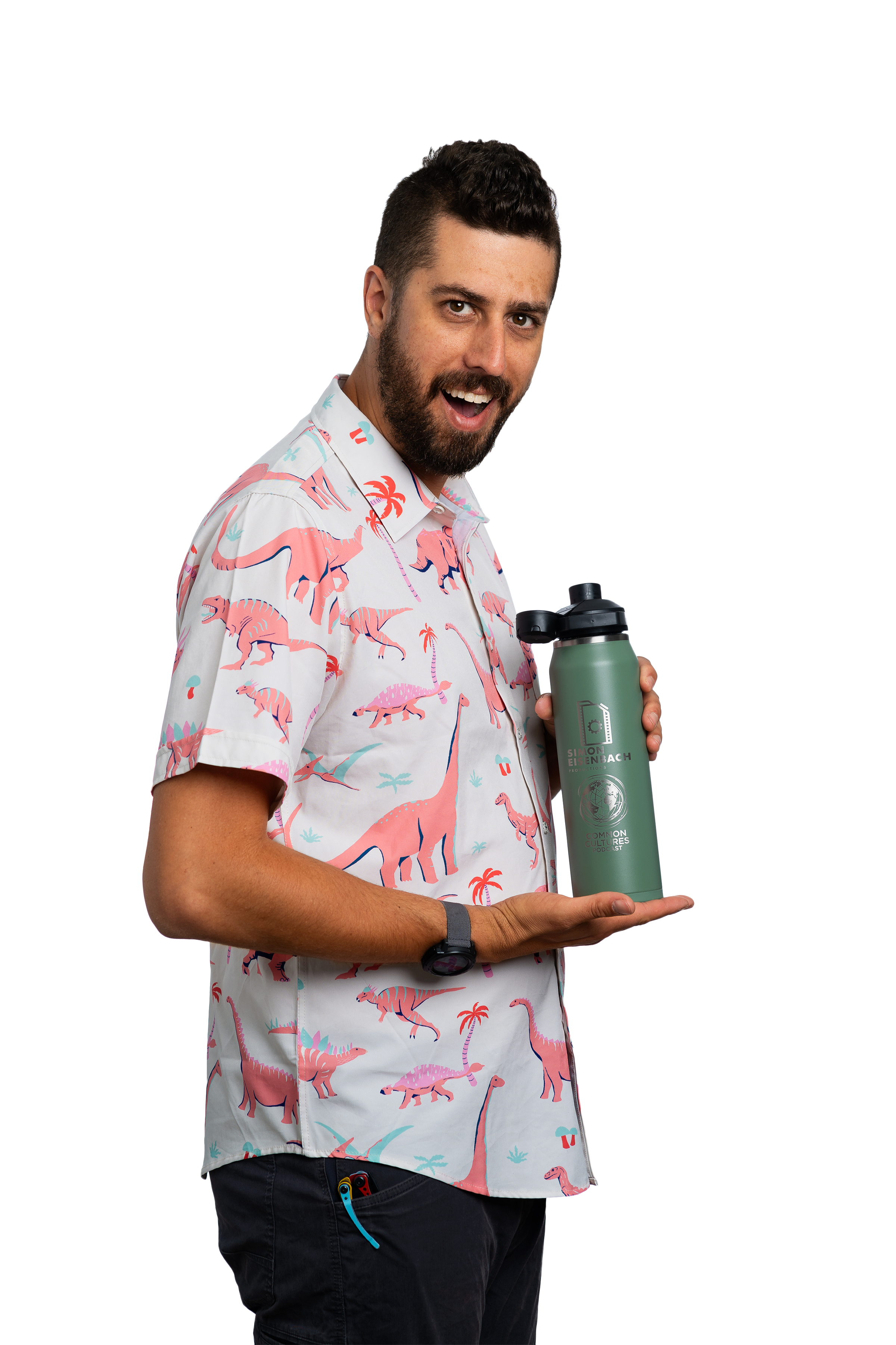 A man with a beard and short dark hair, wearing a white short-sleeved shirt with pink dinosaurs and palm trees, holding a green water bottle with a black cap and a logo that says 'Simon Eisenbach,' standing against a plain white background.