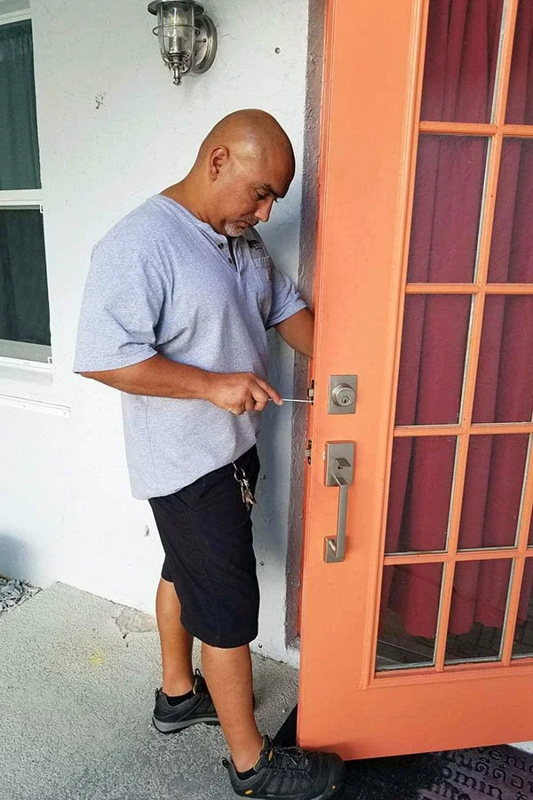 Alex at work on a homeowner's door lock.