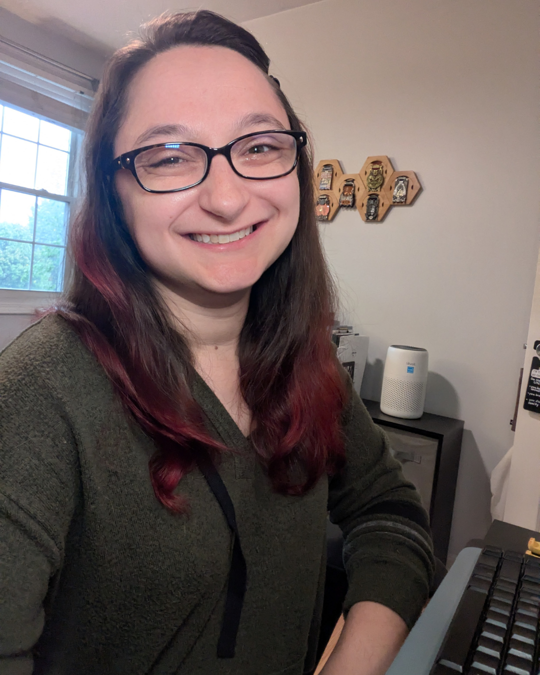 Lindsay Sfara smiling at her desk