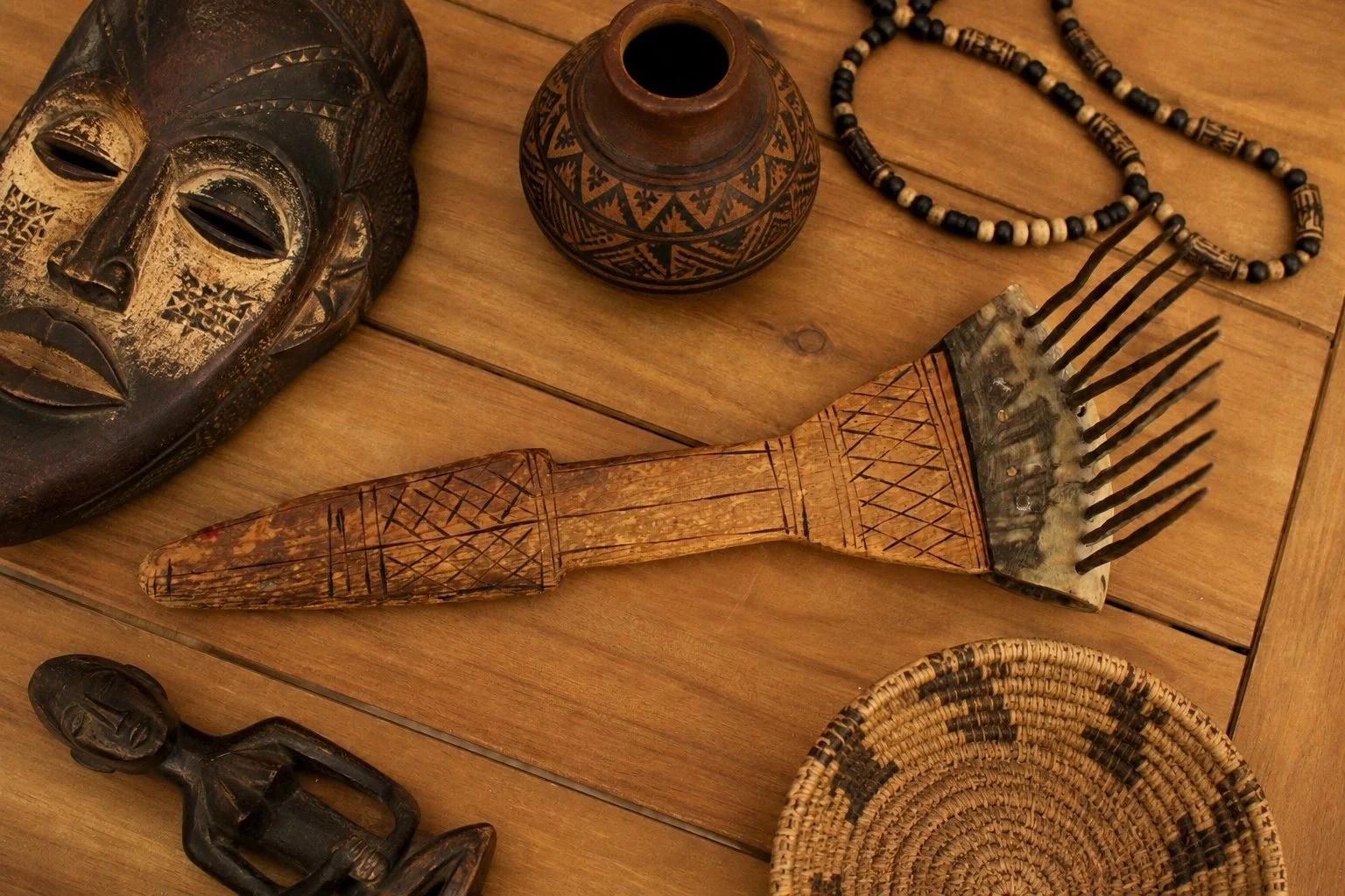 African Carved Wooden Fiber Comb with Forged Iron Spikes-Up-Facing-Front-Handle-on Table with Artifacts-1536 x 1024.jpg