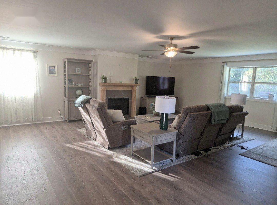 New LVP floors and paint throughout, with a freshly stained fireplace mantel — client addition, Huntsville AL