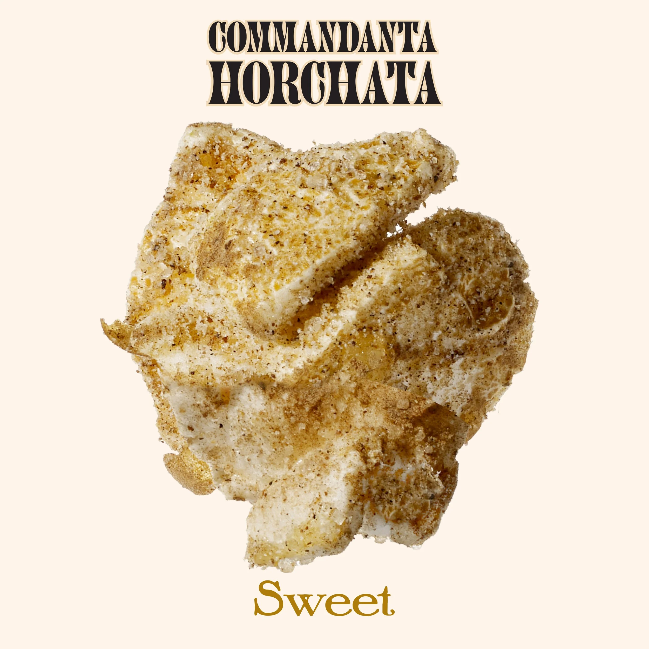 A popcorn coated with seasoning with the text "COMMANDANTA HORCHATA" at the top and "Sweet" at the bottom.