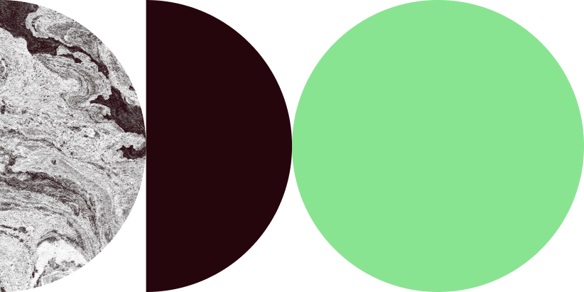 A close-up of a marble surface with organic swirling patterns and a section of a dark-colored object.