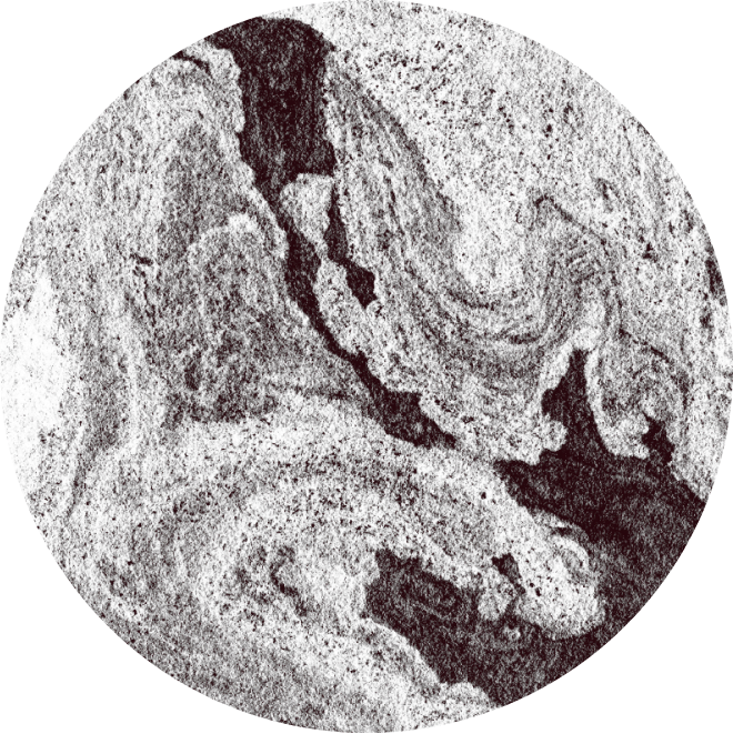 Close-up of a textured, gray stone surface with wavy patterns and rough areas.