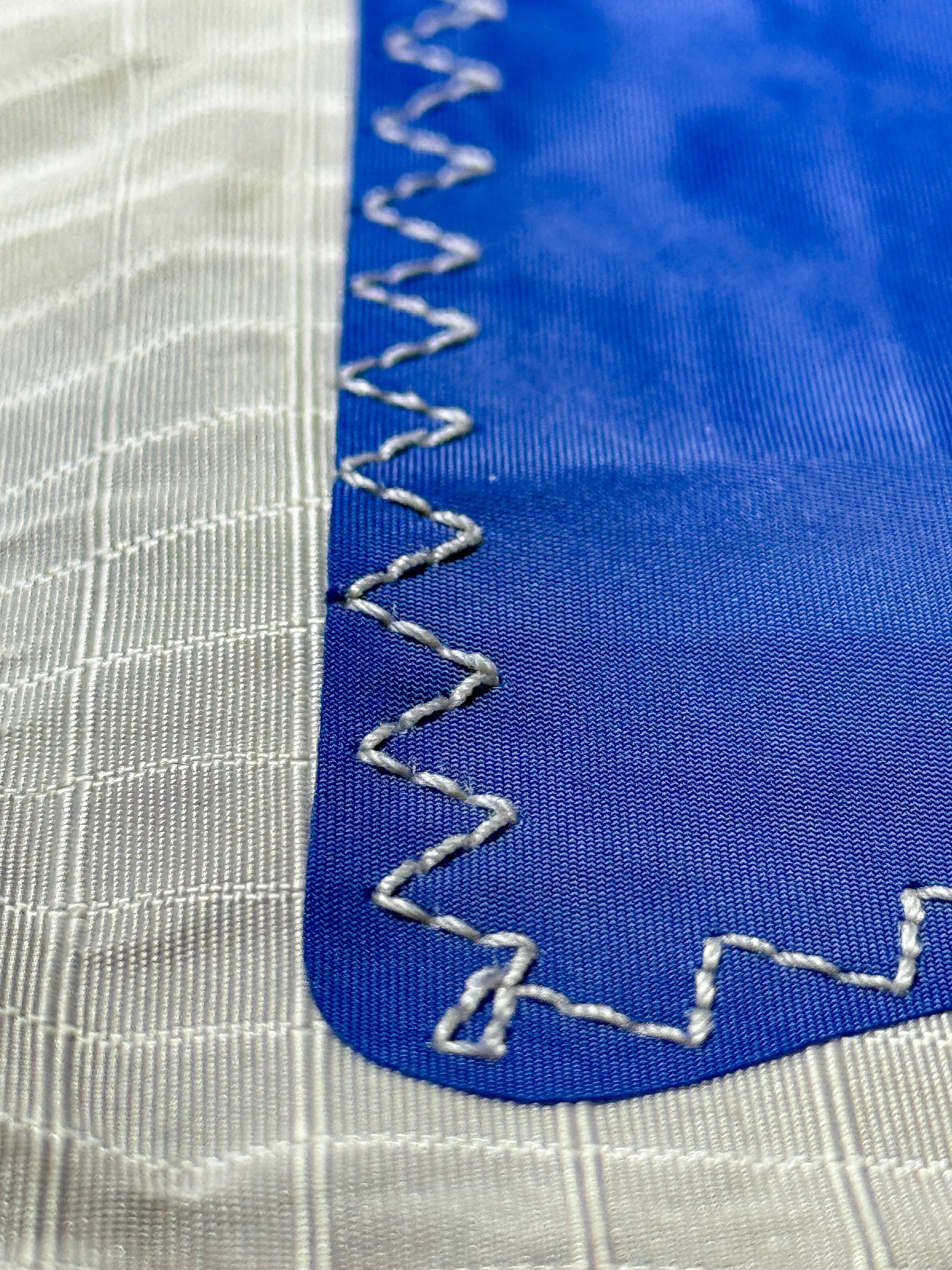 Close-up of an embroidered NASA logo on a fabric surface.
