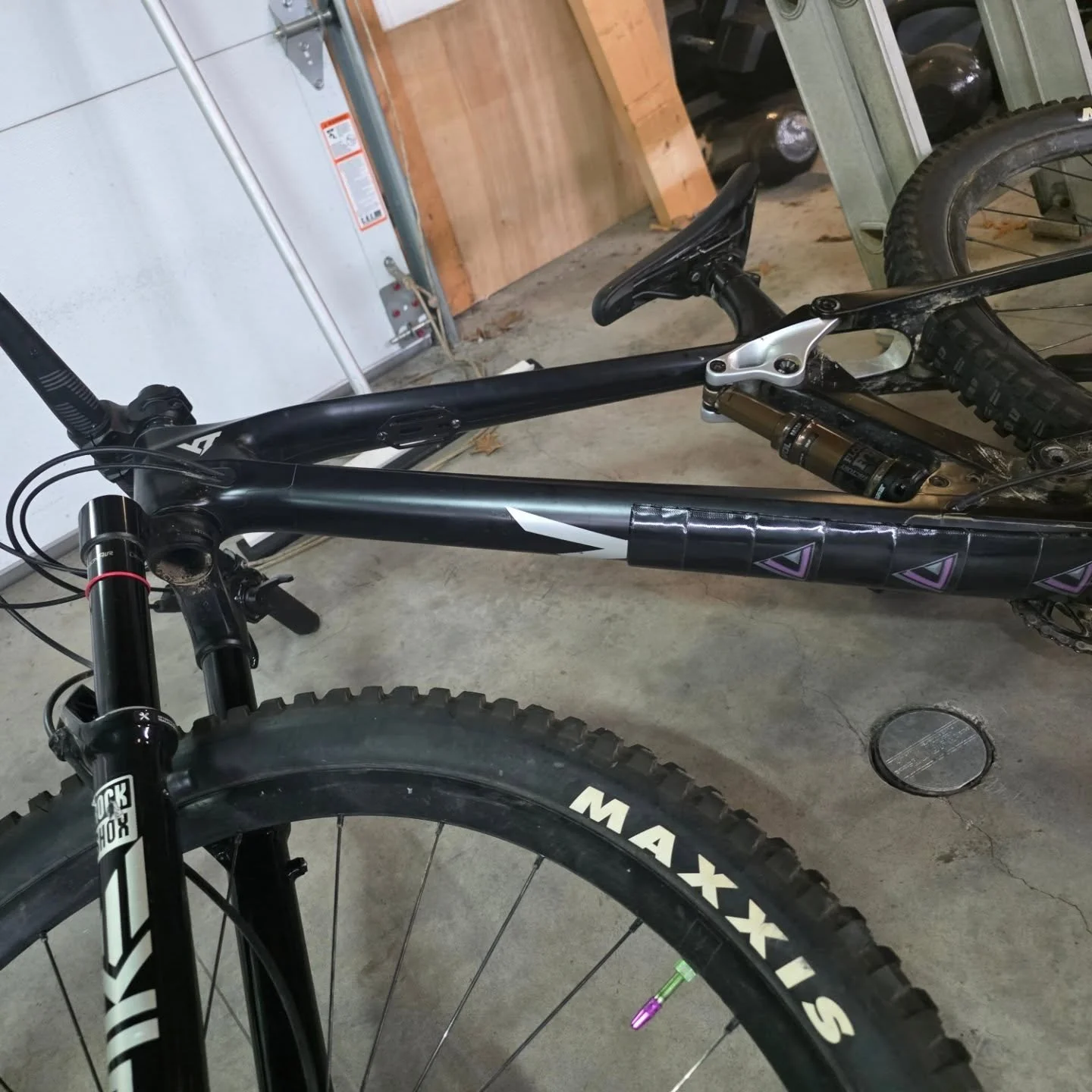 Introducing the Katana Blade Guard - Gloss Black (Silver/Purple logo). The blade guard forms perfectly to the geometry and shape of your mountain bike. Find out more at www.aetherlabsmtb.com