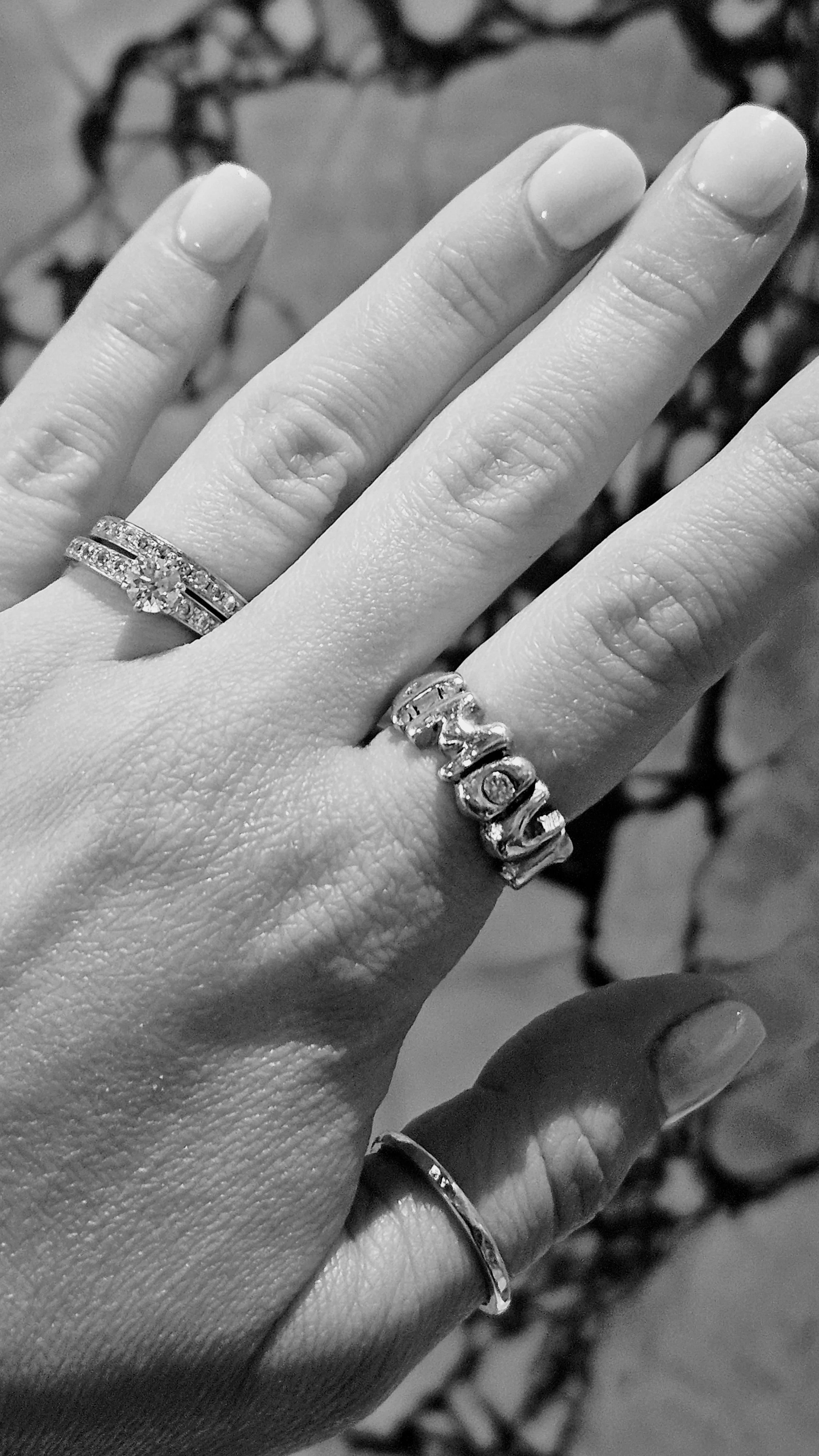 Atelier Moroti word rings stacked — hand-cast fine jewellery worn in London